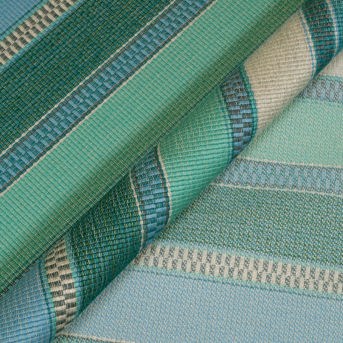 Close-up of green and blue striped fabric with woven patterns