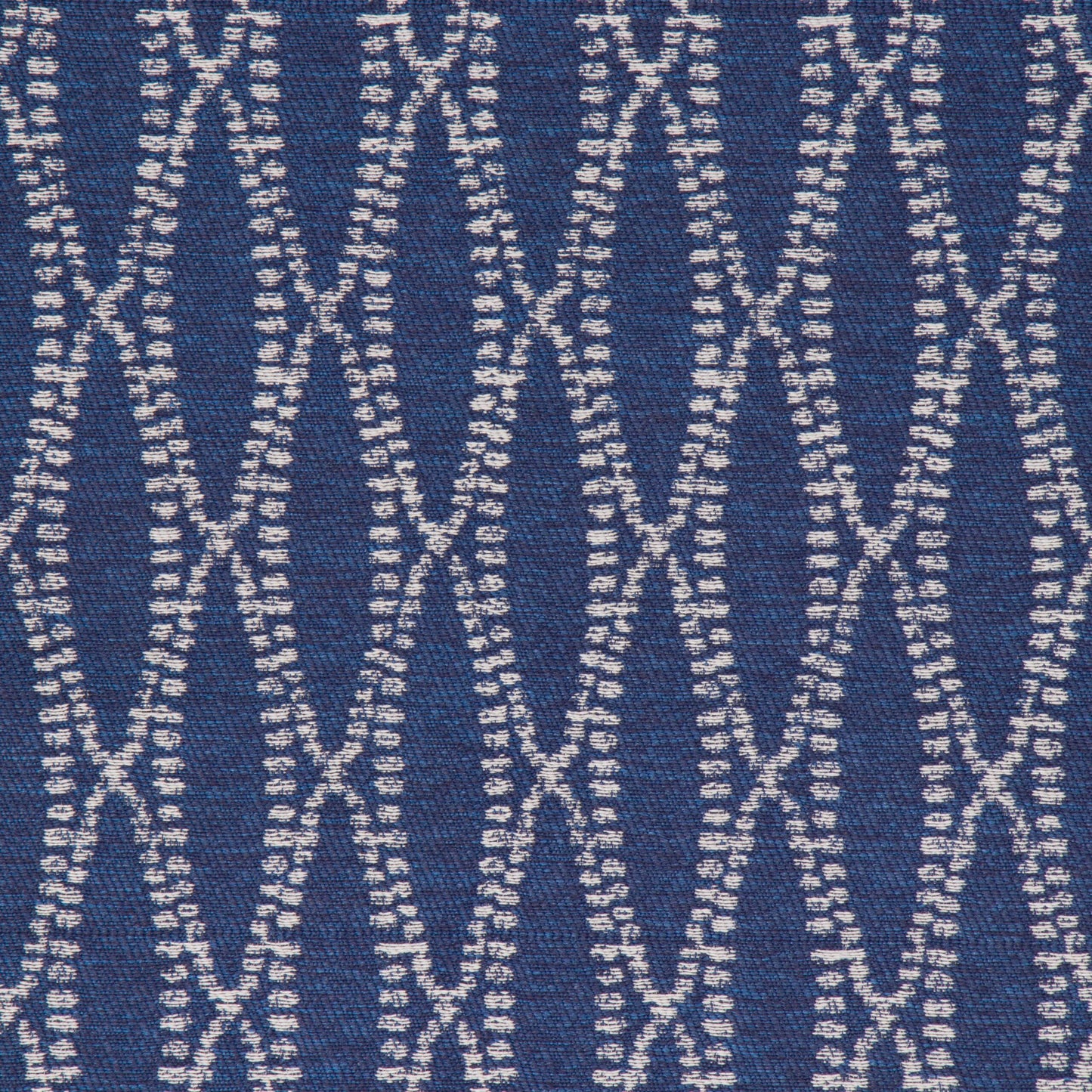 A close-up view of a textured fabric with a geometric pattern in blue and white colors.