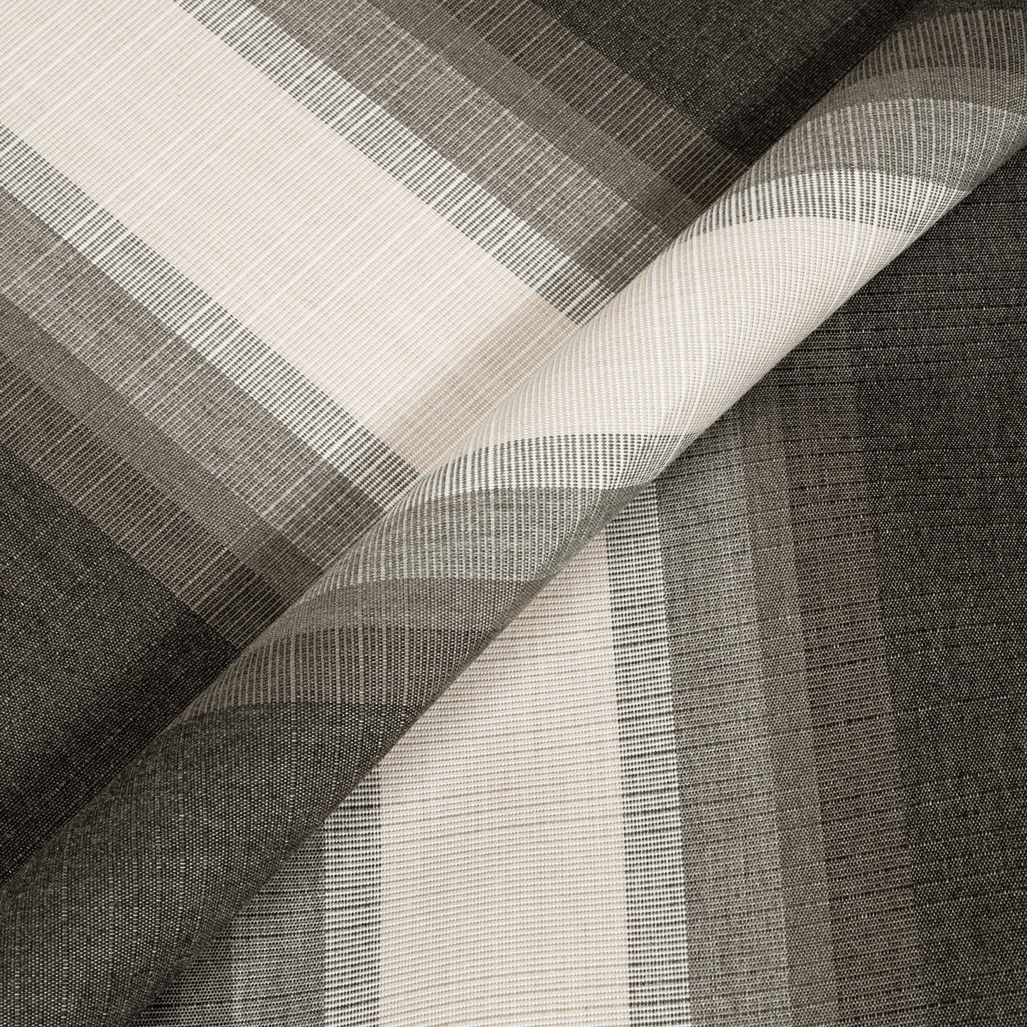 Close-up of woven fabric with a geometric pattern in black, white, and gray.
