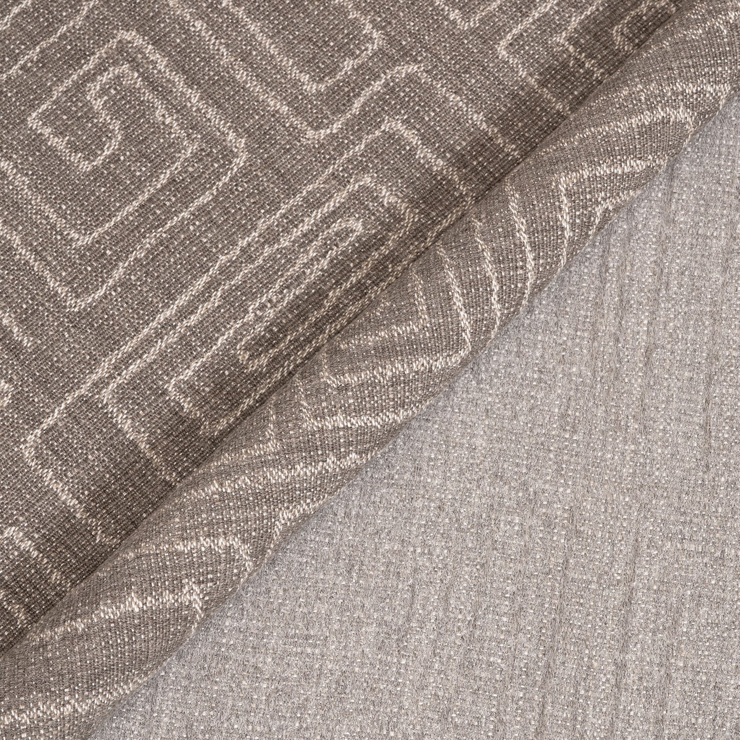 Textured fabric with a geometric pattern in shades of brown and gray.