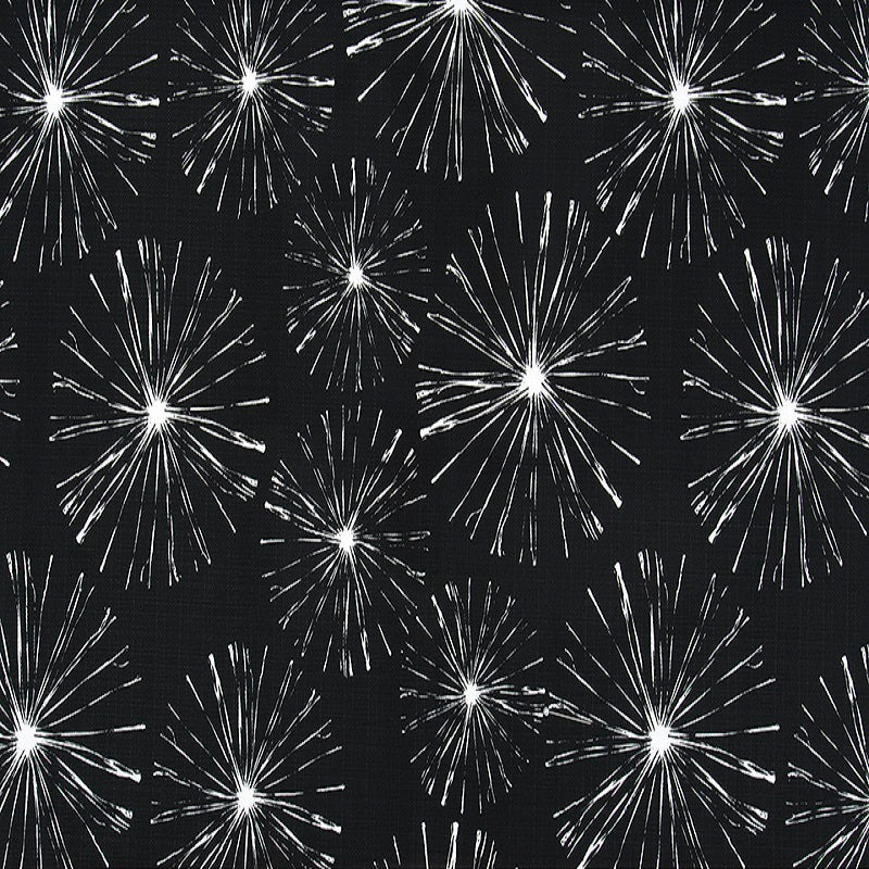 A fabric with a black background featuring a white fireworks pattern.
