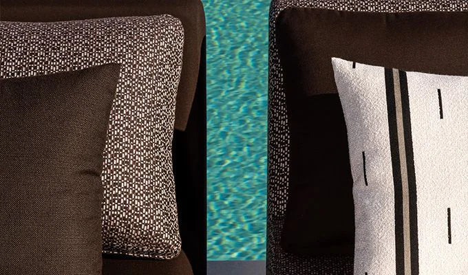 Close-up of patterned cushions on a chair with a pool in the background