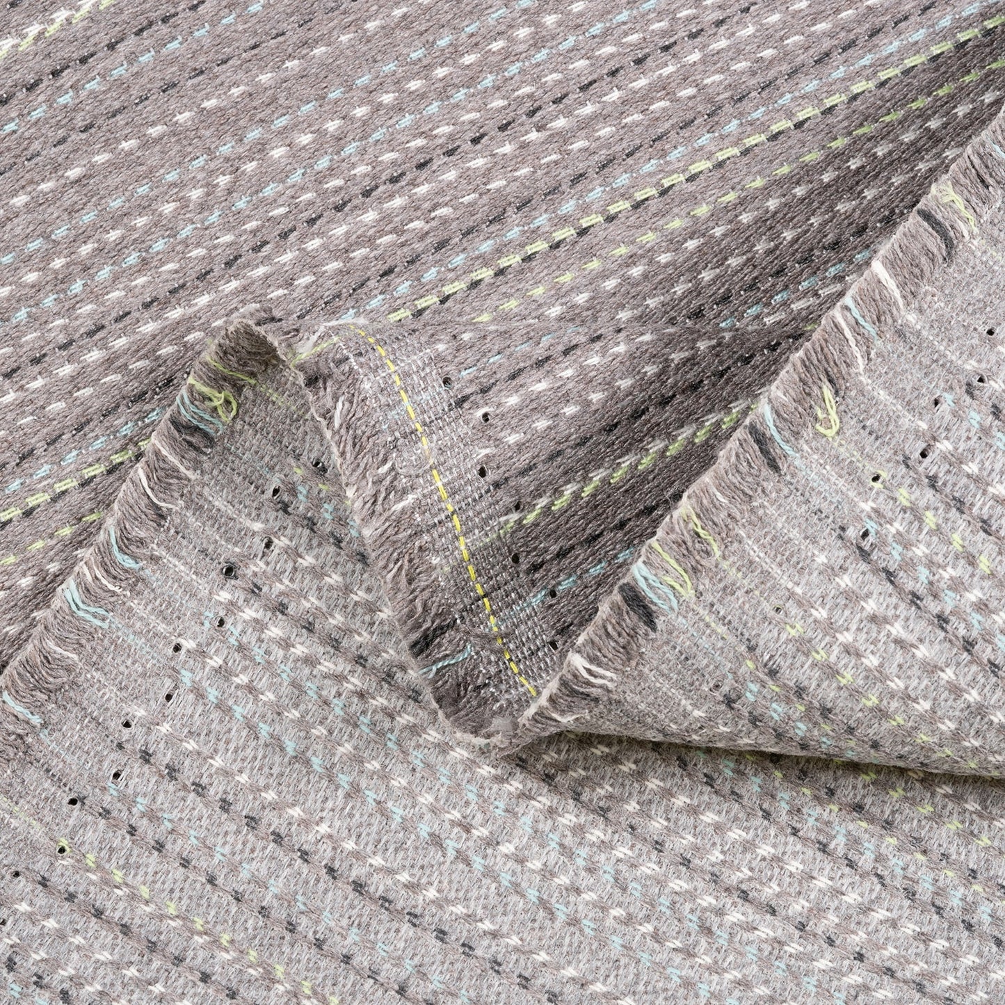 Close-up of gray textured fabric with stitching details