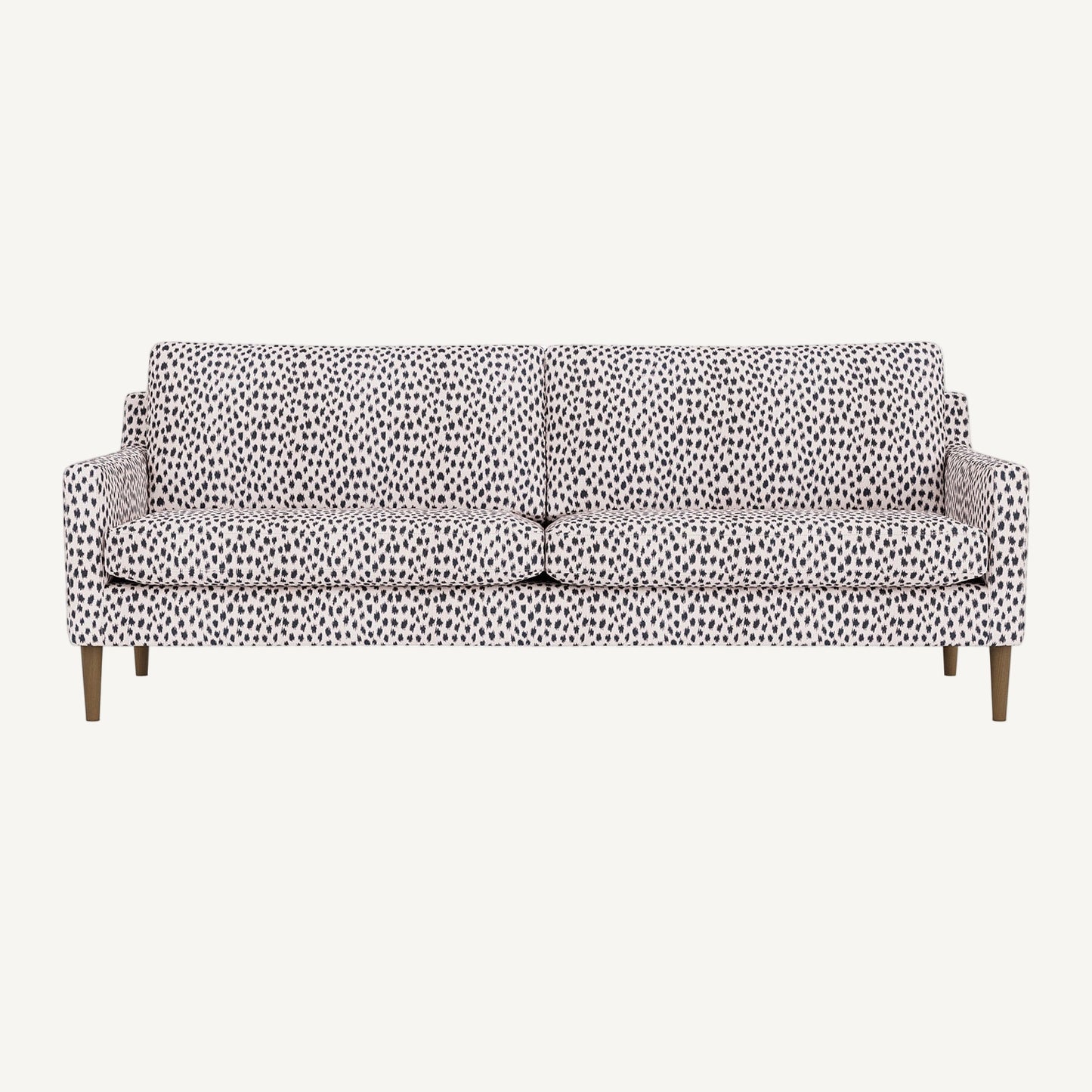 Sofa with a leopard patterned cover on a white background