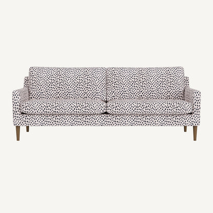 Sofa with a leopard patterned cover on a white background