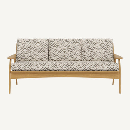 Wooden sofa with patterned cushions on a white background