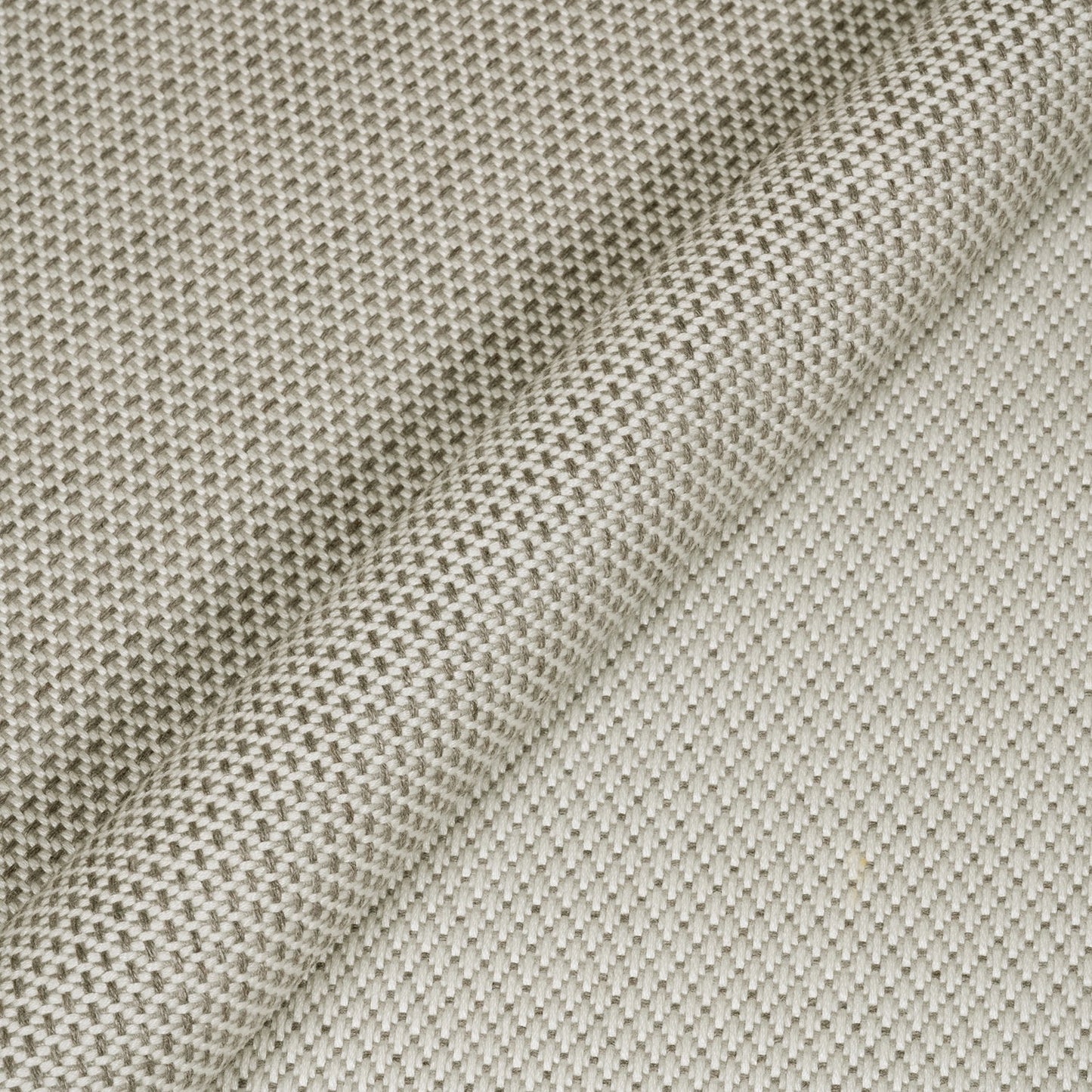 Close-up of textured beige fabric with a subtle pattern