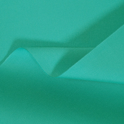 Close-up of teal fabric with a subtle texture