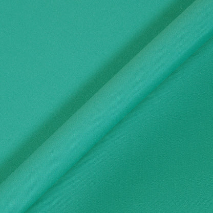 Close-up of teal fabric with a subtle texture
