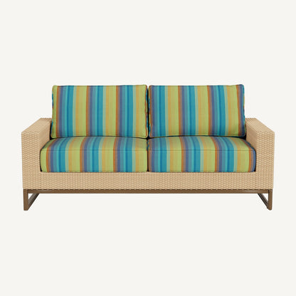 Striped fabric sofa cushion on a wicker sofa