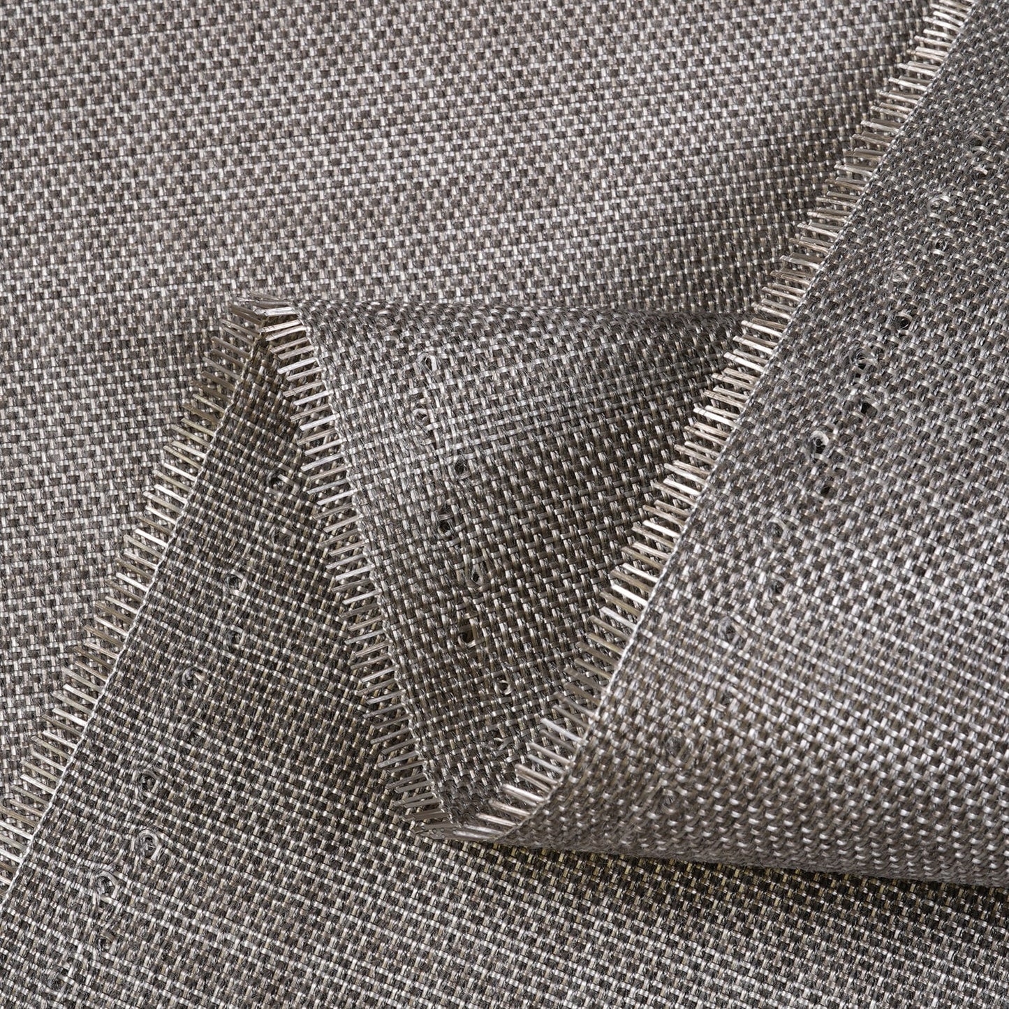Close-up of gray woven fabric with a clear plastic overlay