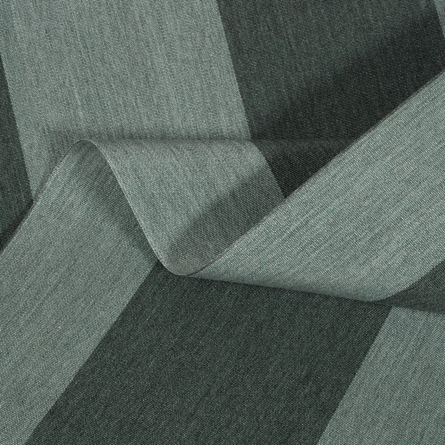 Textured fabric roll with a green and black pattern