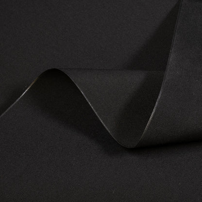 Black fabric with a subtle texture and fold on a black background