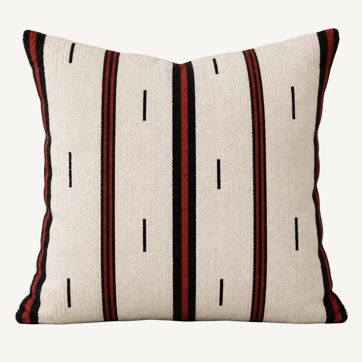 A square decorative throw pillow with a textured off-white woven fabric, featuring vertical stripes in black and dark red, with small black dash marks.