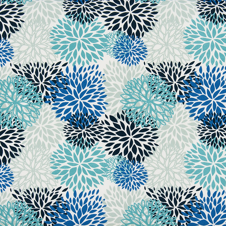 Patterned fabric with blue and black floral designs on a ruler for scale.