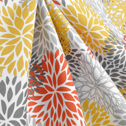 Close-up of fabric with yellow, gray, and orange floral patterns.