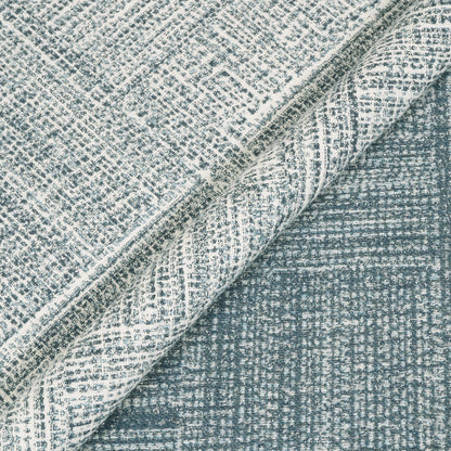 Textured fabric with a checkered pattern in shades of blue and gray.
