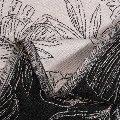 Close-up of fabric with black floral pattern on a neutral background