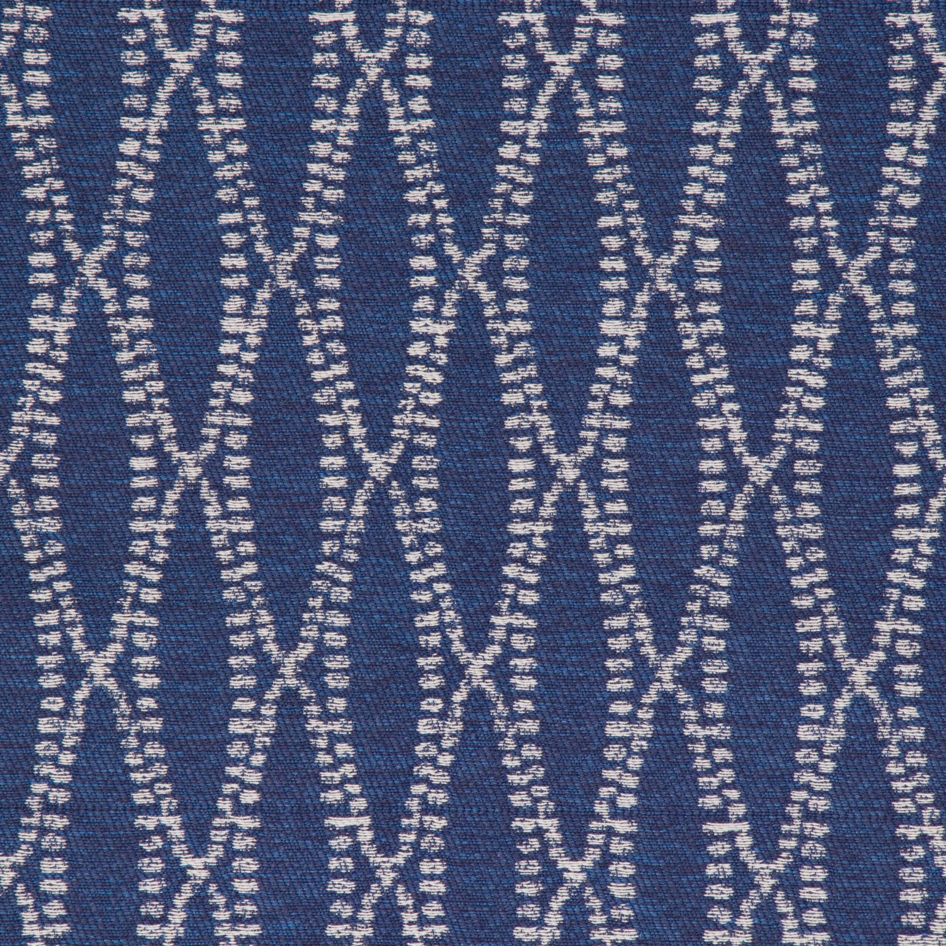 A close-up view of a textured fabric with a geometric pattern in blue and white colors.