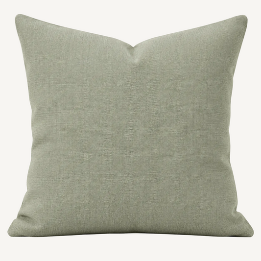 A square throw pillow in a textured sage green linen fabric, shown against a plain white background.