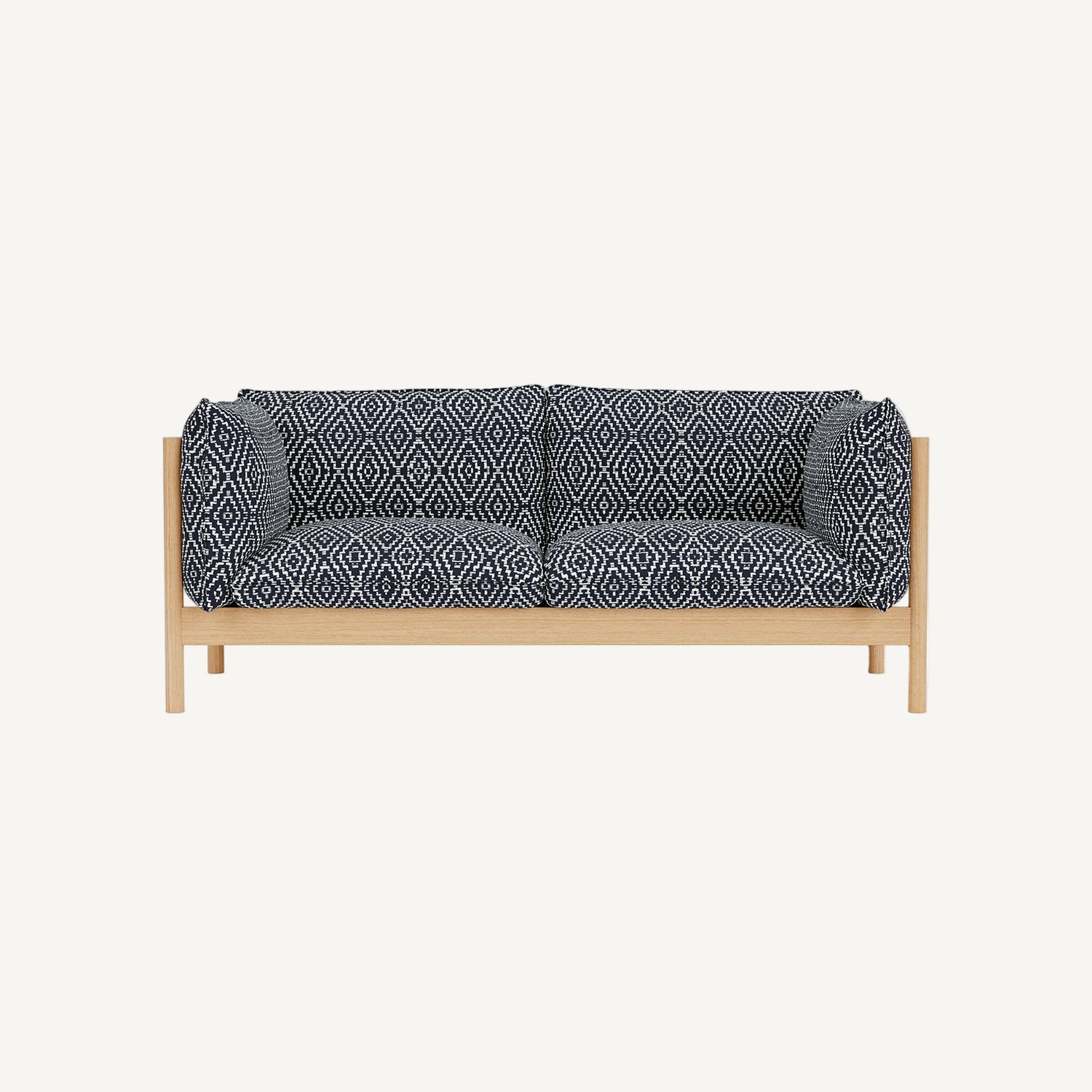 Sofa with dark blue patterned cushions on a white background