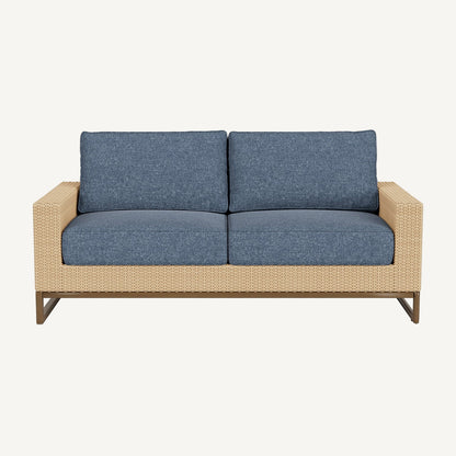 Two-seater outdoor sofa with blue cushions and a wicker frame on a white background