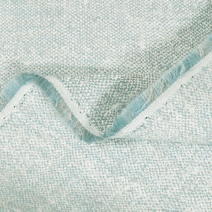 Close-up of textured light blue fabric with a wavy edge