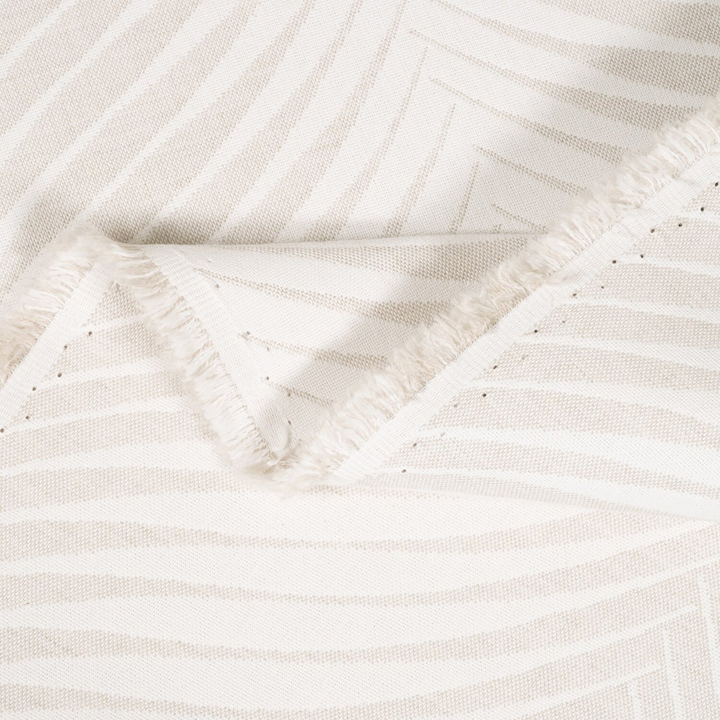 Close-up of textured beige fabric with subtle pattern
