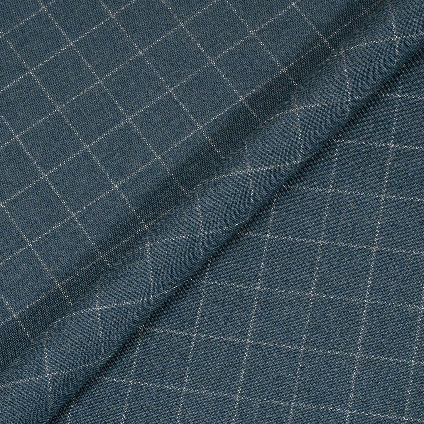 Close-up of blue fabric with a subtle check pattern
