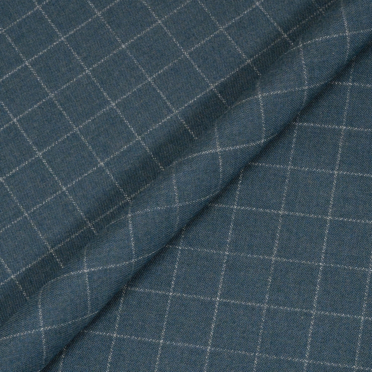 Close-up of blue fabric with a subtle check pattern