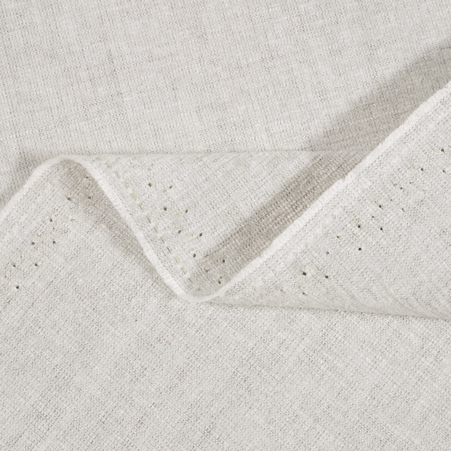 Close-up of textured light gray fabric with a subtle pattern