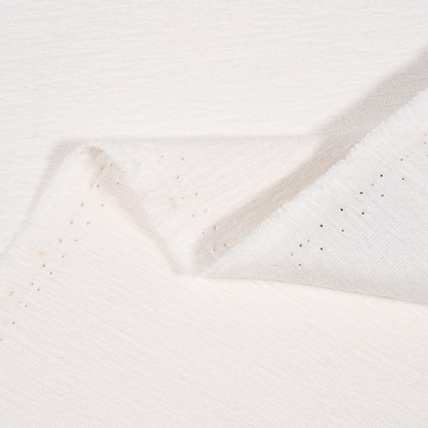Close-up of textured white fabric with a subtle pattern