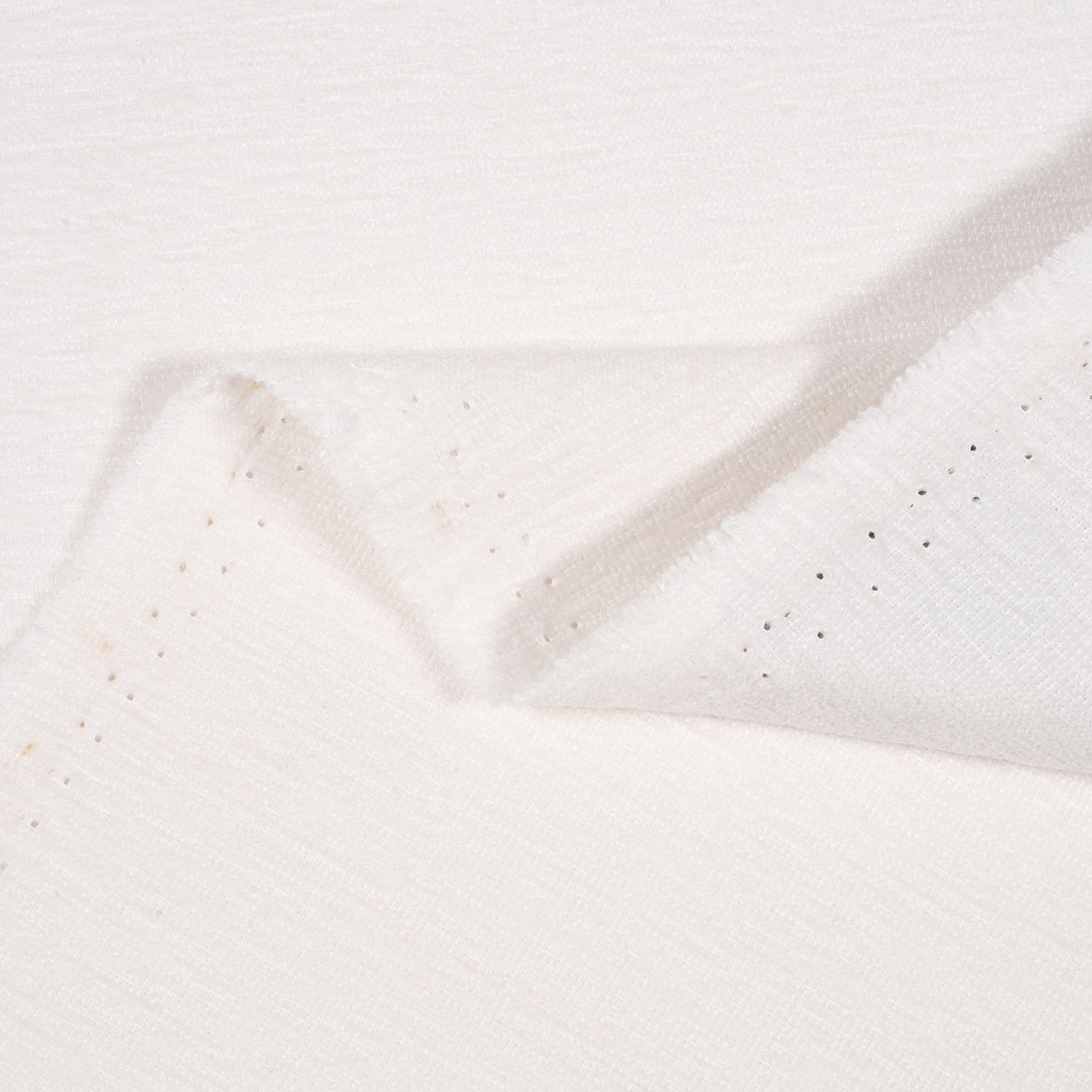 Close-up of textured white fabric with a subtle pattern