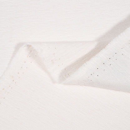 Close-up of textured white fabric with a subtle pattern