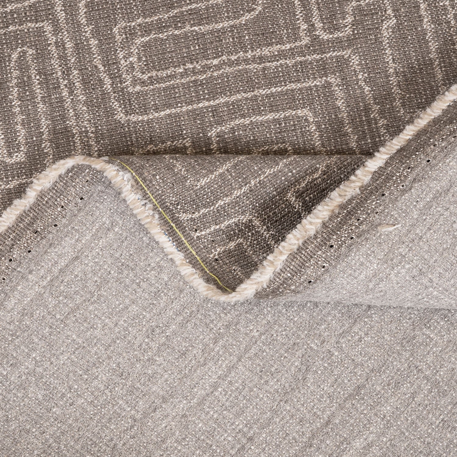 Close-up of a textured gray rug with geometric pattern