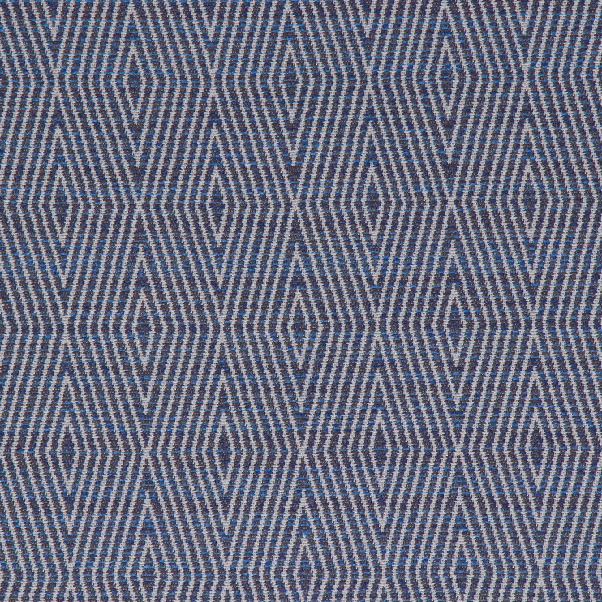 A close-up view of a fabric with a geometric pattern featuring diamond shapes in a variety of shades primarily in blue.