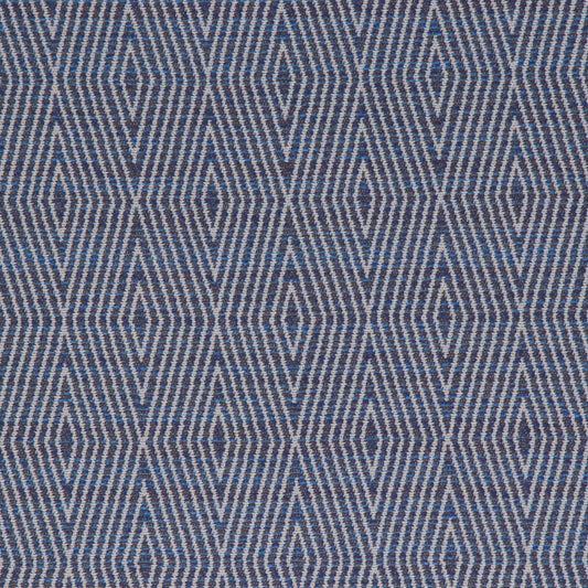 A close-up view of a fabric with a geometric pattern featuring diamond shapes in a variety of shades primarily in blue.