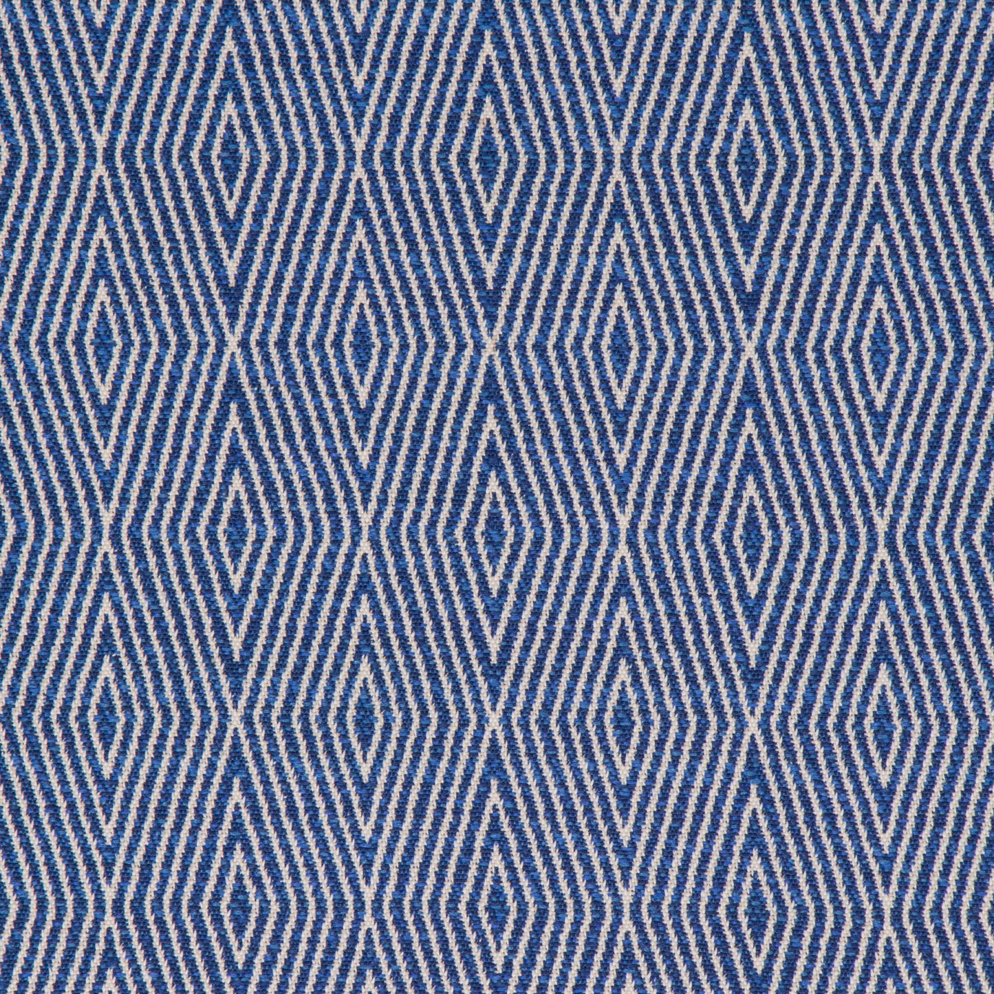 A close-up view of a textured blue fabric with a geometric diamond pattern.