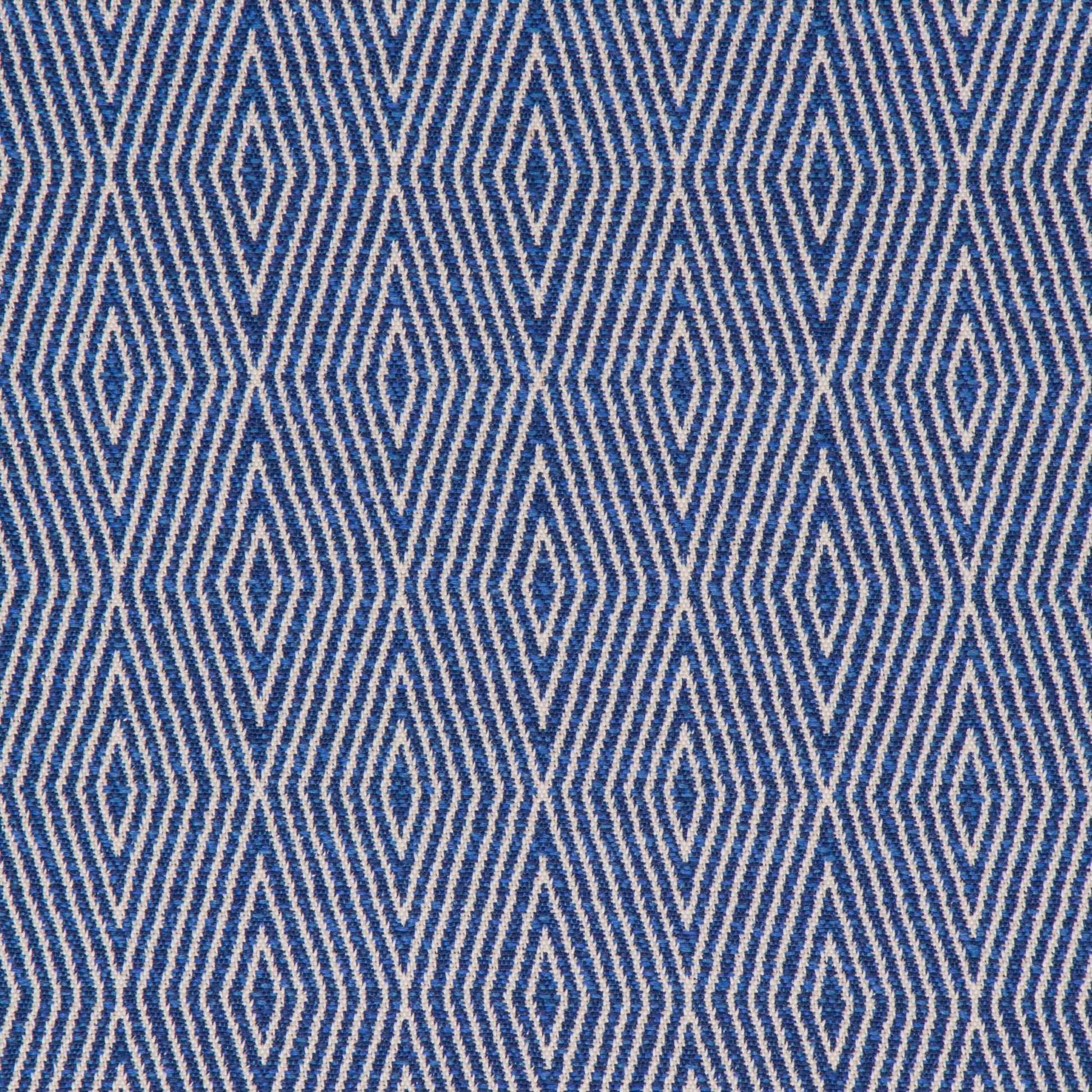 A close-up view of a textured blue fabric with a geometric diamond pattern.