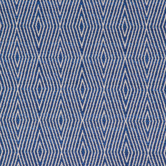 A close-up view of a textured blue fabric with a geometric diamond pattern.
