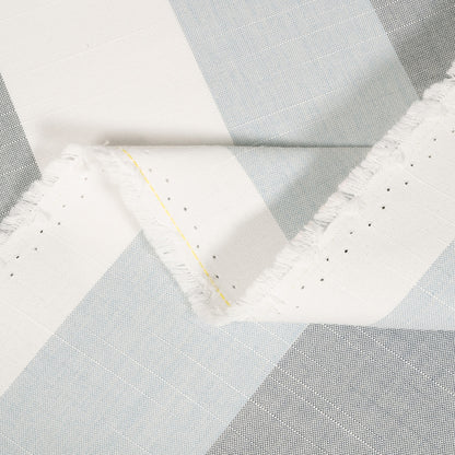 Close-up of a quilt with geometric pattern in gray and white.