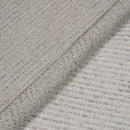 Close-up of textured beige fabric with a subtle pattern