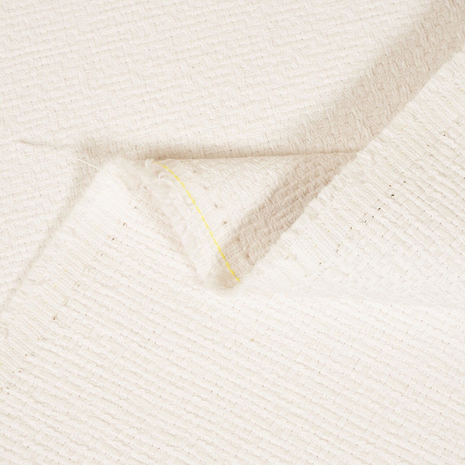 Close-up of textured beige fabric with a subtle pattern