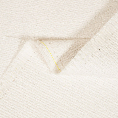 Close-up of textured beige fabric with a subtle pattern