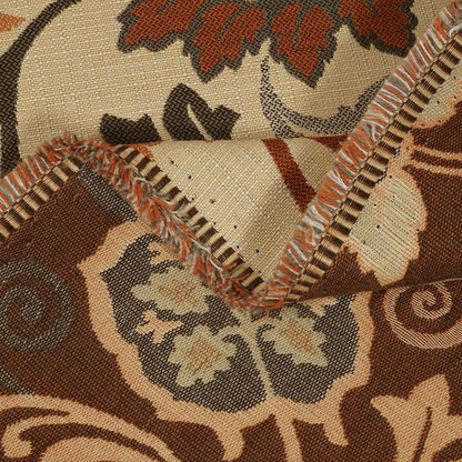 Close-up of a patterned fabric with intricate designs in brown, beige, and black.