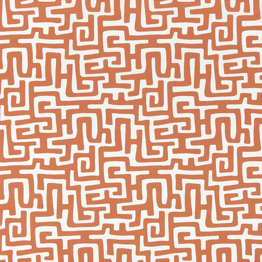 Patterned fabric with white maze-like design on a brown background