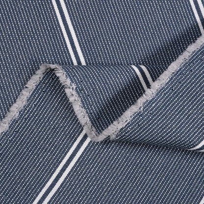 Close-up of blue fabric with white stripes and gray frayed edge