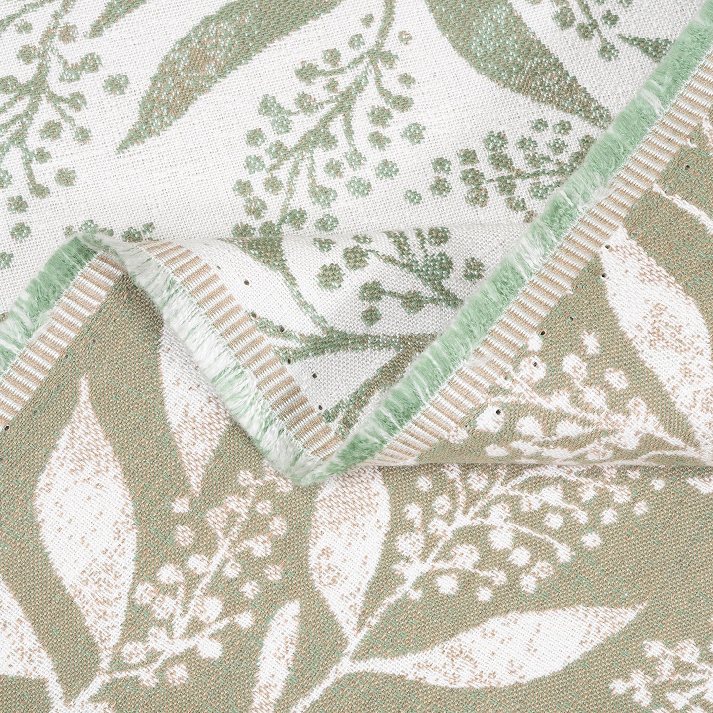 Close-up of fabric with green and beige leaf pattern