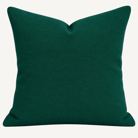 A square throw pillow in a deep emerald green fabric, shown against a plain white background.