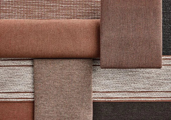 Close-up of fabric swatches in brown, gray, and beige tones.
